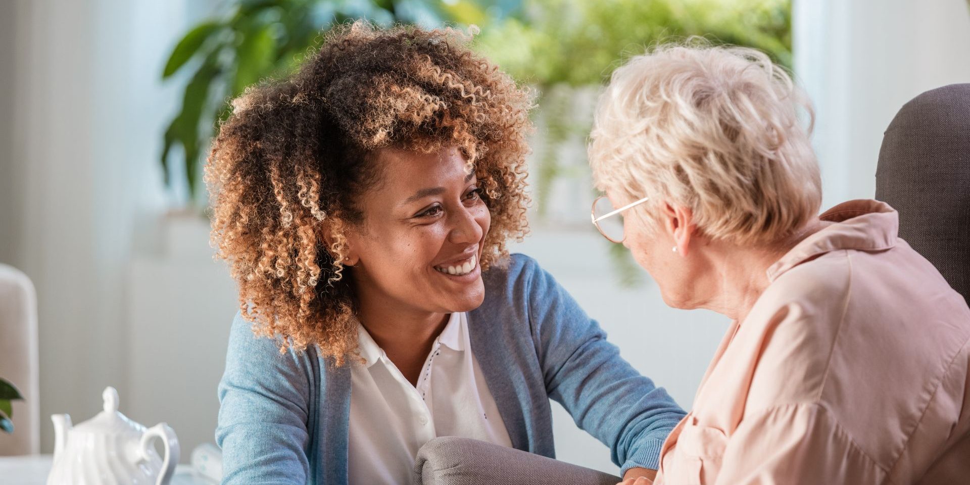 Carer sharing a warm moment with elderly client